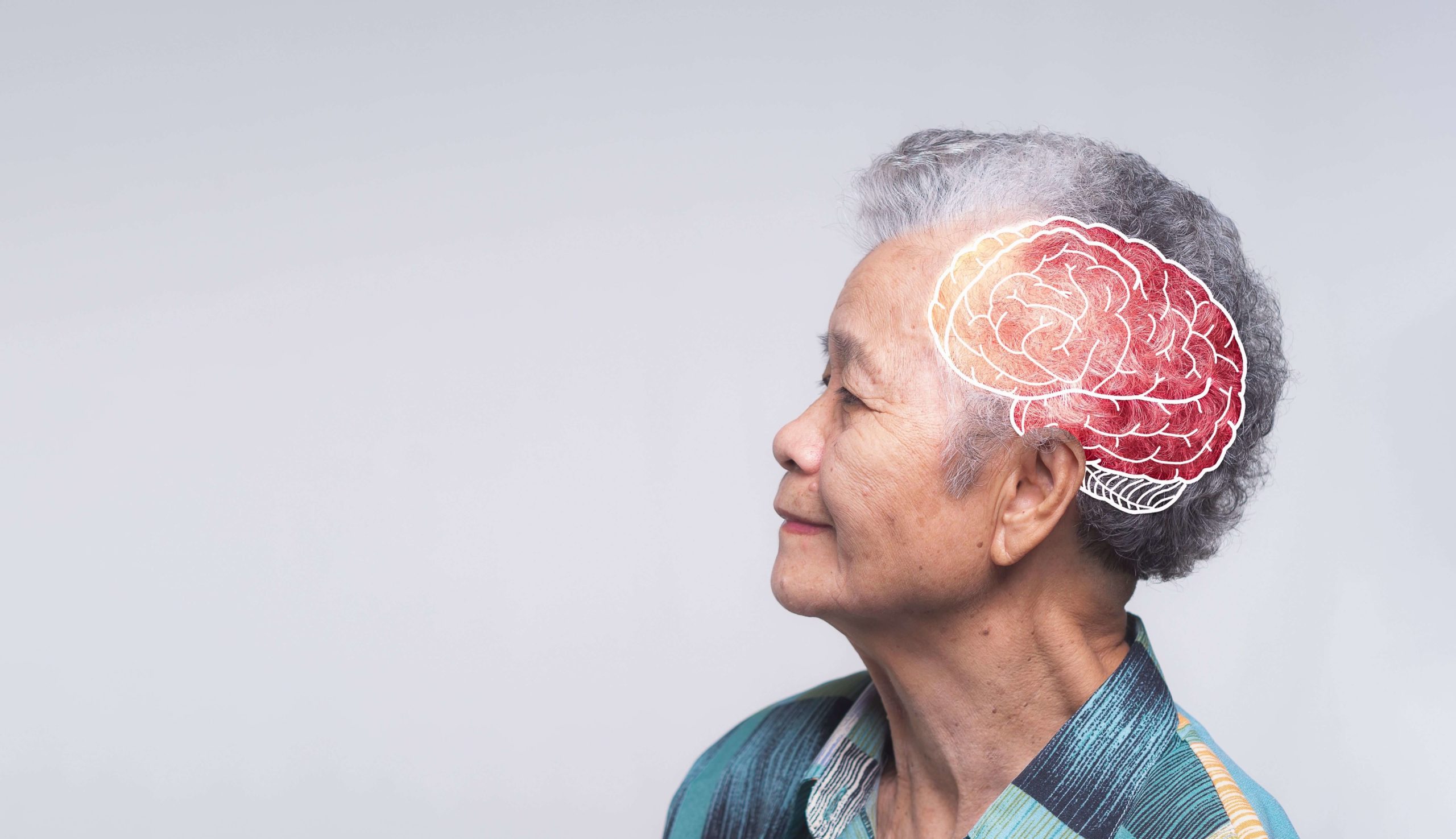 An older woman looking to the side with a drawing of a brain on the side of her head.